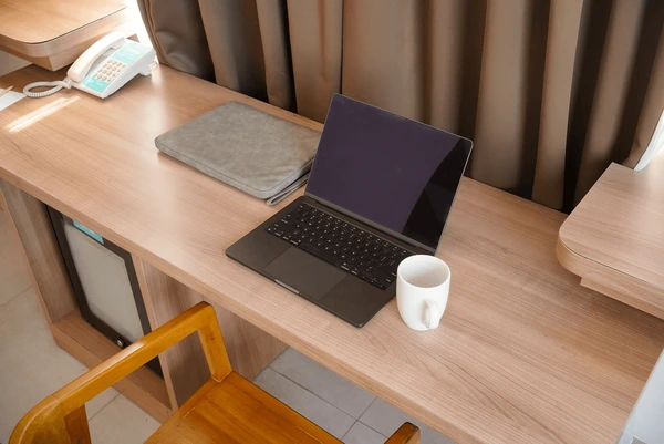 A stack of two notebooks with a pen and ruler on a clean white desk